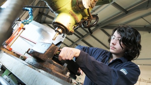 Student using engineering machinery.
