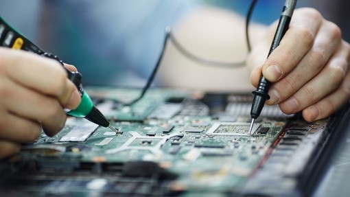 close up checking-current-laptop-circuit-board