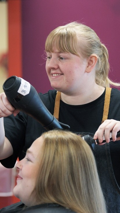 A student using a blowdryer.