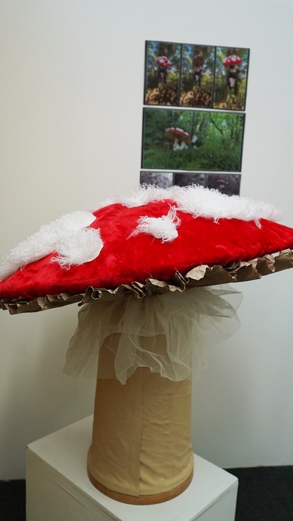 A red and white topped mushroom made from textiles