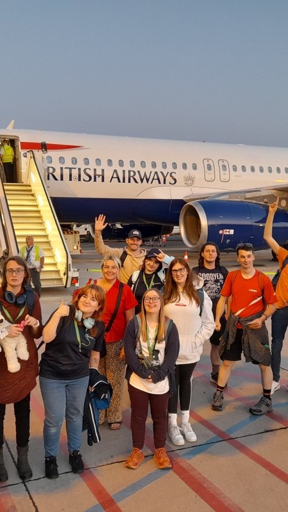 Students lined up in front of a British Airways plane