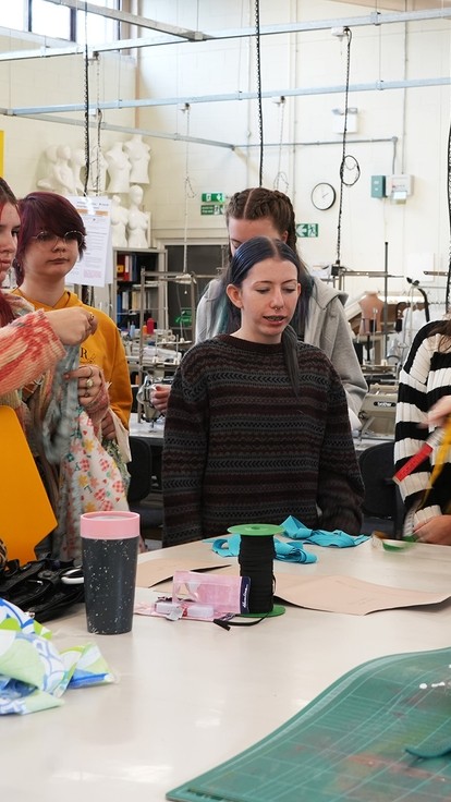 Tammy, resident fashion graduate guiding the students 