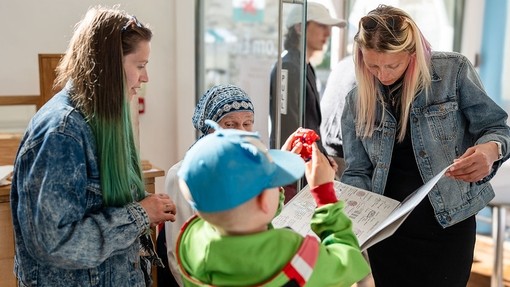 A family looking at student work at an open day.