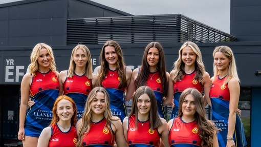 Netball team in red and blue uniform.
