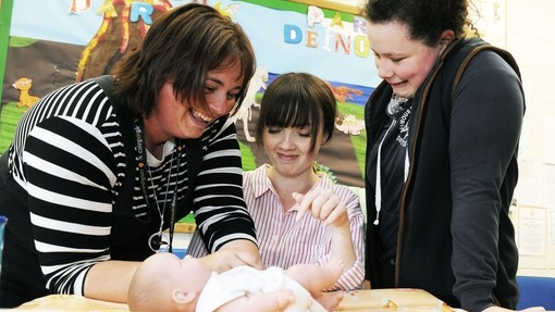A teacher guiding her student
