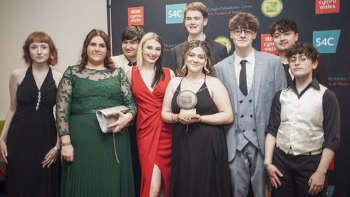 group of winner holding award