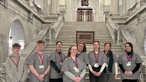 Students standing on the steps of a government building