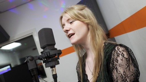 Student singing into a microphone.