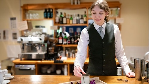 Student serving a decorative cocktail