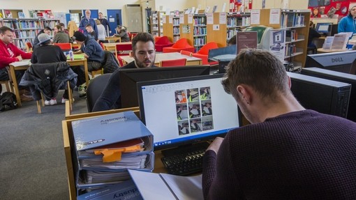 2 students working at computers in the library