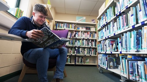 student reading in the library
