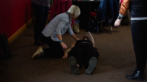 care24 learners practicing first aid techniques on each other