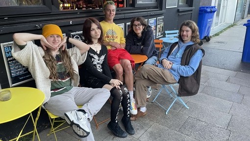 Katalogen band sitting and smiling at camera