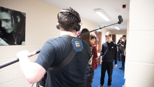 A student holding an extended mic