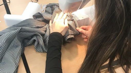 A student sewing with a machine