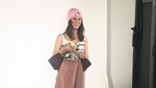 A student wearing a garment on an area used to take photos