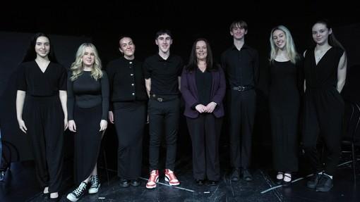 Students performing with a black background