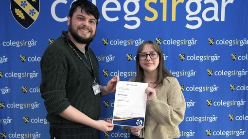 a tutor presenting a student with certificate