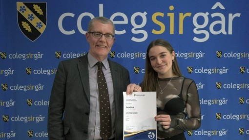 a tutor presenting a student with certificate