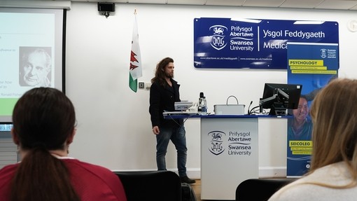 Doctor Kyle talking to students from a podium