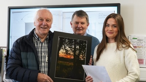 Reps from the photo society (2) with a student presenting her with her certificate