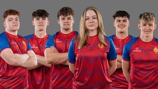 Six students lined up in their red and blue rugby kits