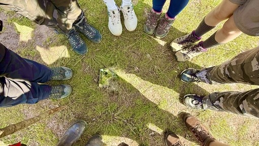 A creative picture of the tops of everyone's shoes looking down
