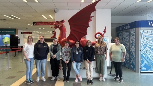 At the airport next to a Welsh dragon