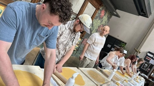 Students in a row taking part in a pasta making session
