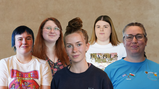 All the students involved in a row looking at the camera