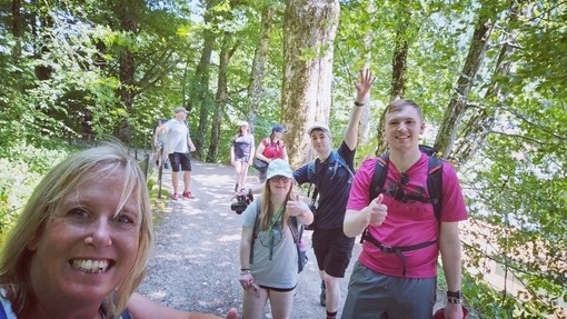 A selfie with Helen and some students with woods behind