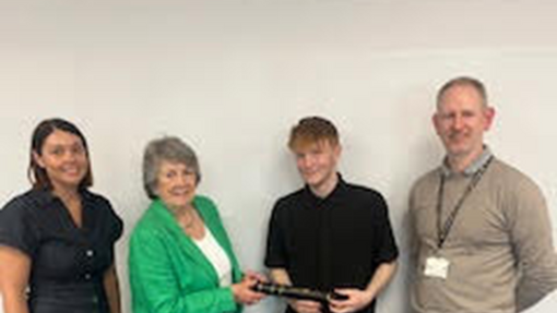Charles shaking hands with a member of the The Worshipful Livery Company of Wales with his catering lecturer and Anna James