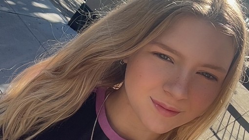 A selfie of Amber wearing a black t-shirt and she has long fair hair