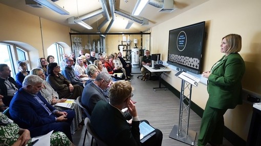 The Acting Principla giving a talk in front of a group of people in the new Green Skills Academy building.