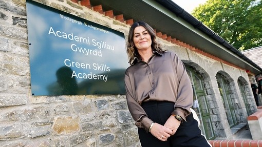 Jemma Parsons by the Green Academy outdoor sign