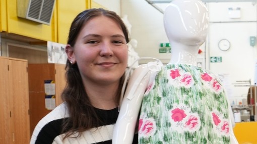 Bethan Green holding her final garment on a child mannequin