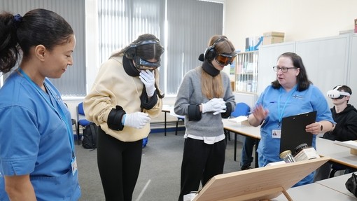Two nurses with two students explaining their task