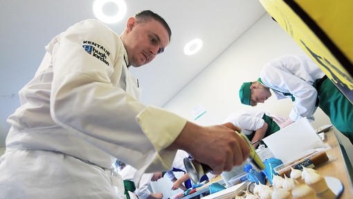 Sam Everton, lecturer, working with a student in the background