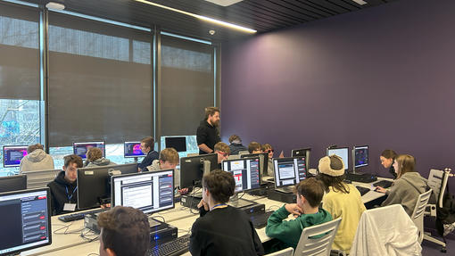 Pupils with computers in a cyber session