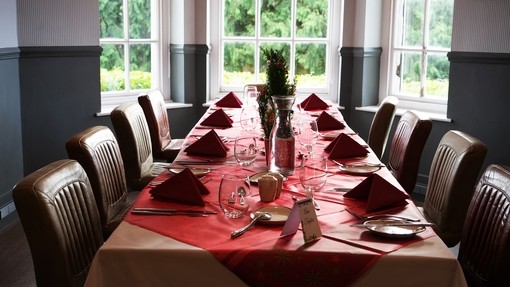 A laid table at the restaurant with Christmas red theme