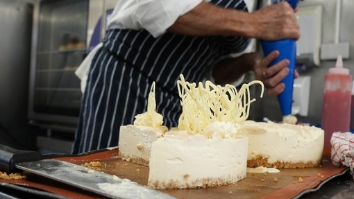 Peter piping some deserts a white chocolate cheesecake with decoration on top