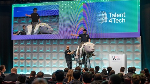 A stage with a man on an animatronic talking to an audience