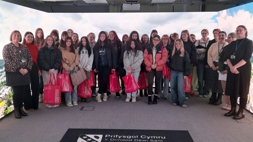 Students in a group in an immersive digital room