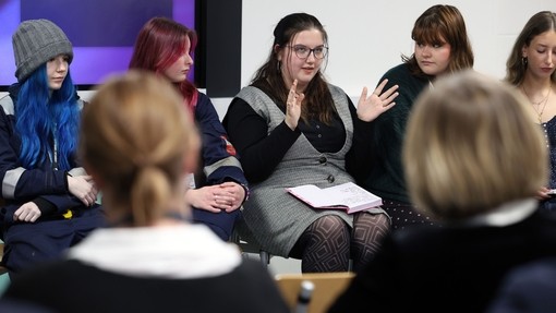 A close up of a student talking within the panel