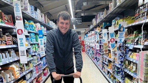 Ci in the shop pushing a stock trolley