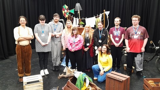 Students on the theatre performance area with the actors and props in the dress rehearsal