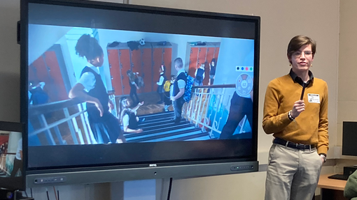 Ricardo standing in front of a whiteboard showing his presentation 