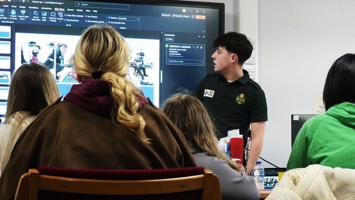 Zach explaining something in his presentation to the group 
