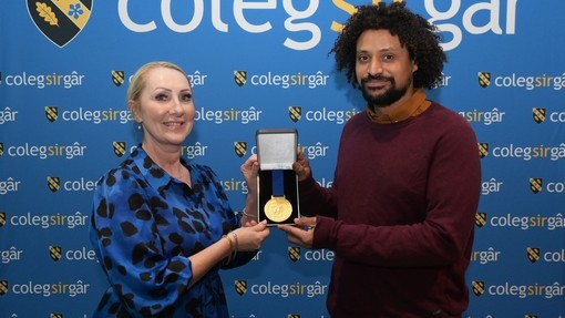 Claire MacKerras with a student and medal