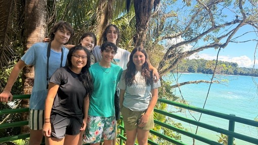 Hannah with her overseas family outside on a sunny day